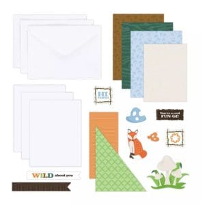 Contents of the Creative Memories NSD 2024 Card Kit including card bases, envelopes, and fox and mushroom-themed embellishments.