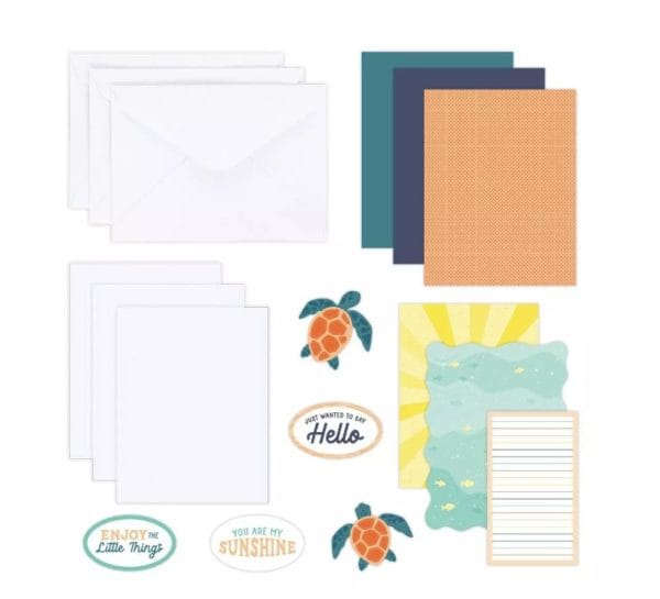 Contents of the Creative Memories Sun-Soaked Trio Card Kit, including card bases, envelopes and tropic-themed embellishments like sea turtles.