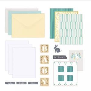 Contents of the Creative Memories Welcome Baby Trio Card Kit including envelopes, card bases, and baby-themed embellishments