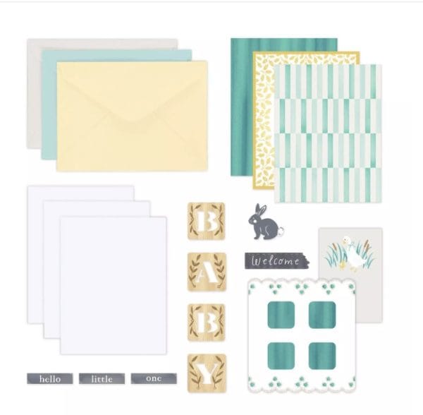 Contents of the Creative Memories Welcome Baby Trio Card Kit including envelopes, card bases, and baby-themed embellishments